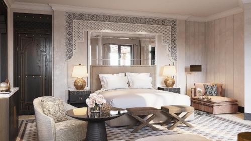 a bedroom with a bed and a table and a chair at Jumeirah Dar Al Masyaf Dubai in Dubai