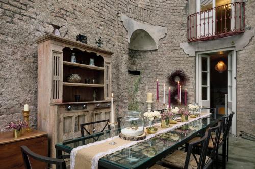 a dining room table with candles and flowers on it at Loughcrew House in Oldcastle