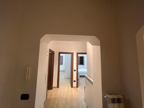 a hallway with an archway leading to a bedroom at MARTA'S APARTMENT ROCCARASO in Roccaraso