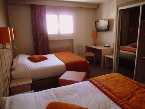 a hotel room with two beds and a window at The Originals City, Hôtel Rey du Mont Sion, Saint-Julien-en-Genevois Sud in Saint-Blaise