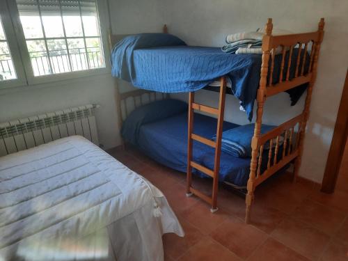 a bedroom with two bunk beds and a bed at Shivanda, Habitaciones en Centro de Bienestar en la Naturaleza in Pioz