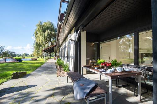 a patio with a wooden table and a bench at SCHLOSSRESIDENZ - Boutique Apartments & Hotel Suiten in Schloß Ricklingen
