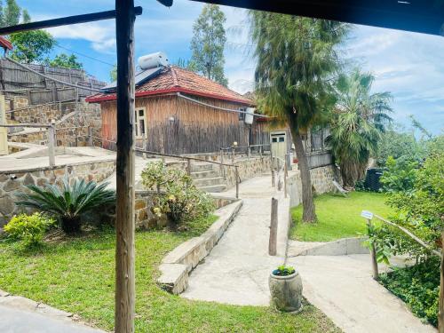 a house with a pathway leading to a building at Kivu Macheo eco-lodge in Kibuye