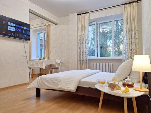 um quarto com uma cama grande e uma mesa com comida em Один каштан Мережа Alex Apartments Безконтактне заселення 24-7 em Poltava
