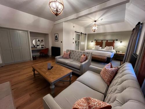 a living room with a couch and a bed at Blackwell Grange Hotel in Darlington