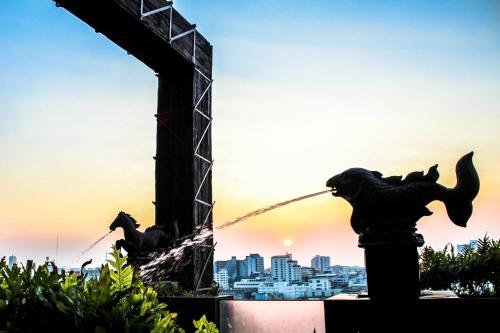 a statue of two horses drinking water from a fountain at Siam@Siam, Design Hotel Bangkok in Bangkok