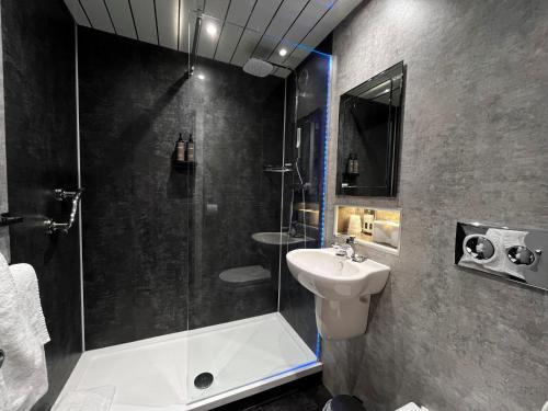 a bathroom with a shower and a sink at Blackwell Grange Hotel in Darlington
