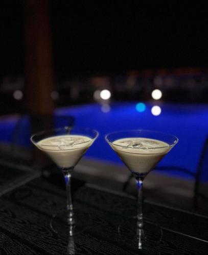 two martini glasses sitting on top of a table at Aparthotel Plat in Kožino