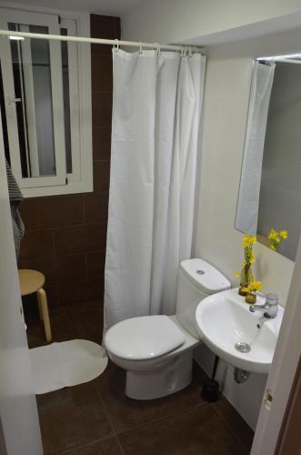a bathroom with a toilet and a sink at Apartment Rovellada Platja in Colera