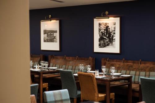 a dining room with wooden tables and chairs at Loch Fyne Hotel & Spa in Inveraray