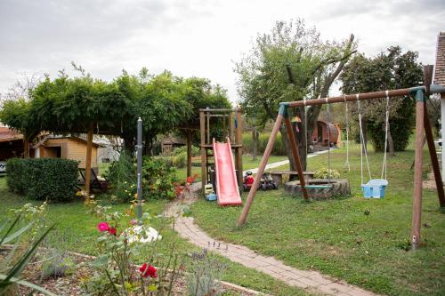 a park with a swing set in a yard at Rózsa Porta in Zengővárkony