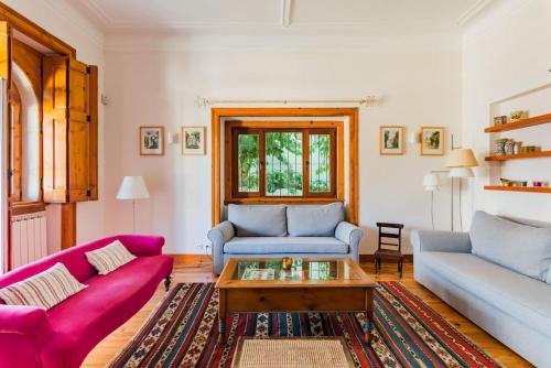 a living room with two couches and a coffee table at Estoril Historical Villa by the Sea in Estoril