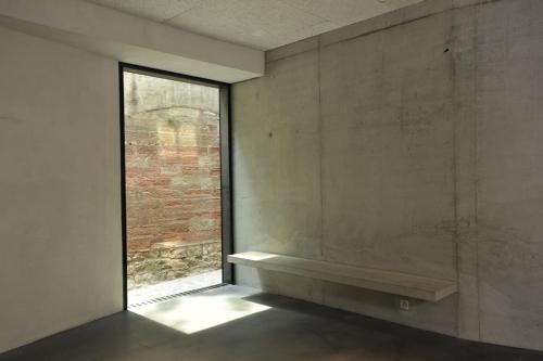 a room with a window and a bench on the wall at Basel Youth Hostel in Basel