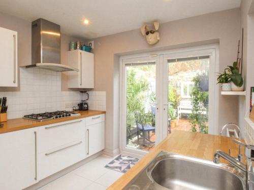 a kitchen with a sink and a large window at Bayview Villa in Portland