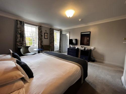 a hotel room with two beds and a television at Blackwell Grange Hotel in Darlington