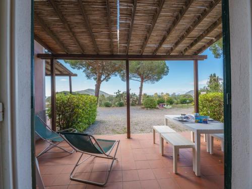 a patio with a table and chairs and a table and chairs at Apartment Elbamar Lacona I-3 by Interhome in Capoliveri