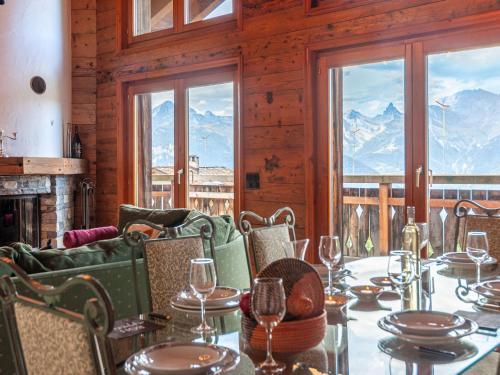 a dining room with a table with wine glasses at Chalet Belle Vue by Interhome in Nendaz