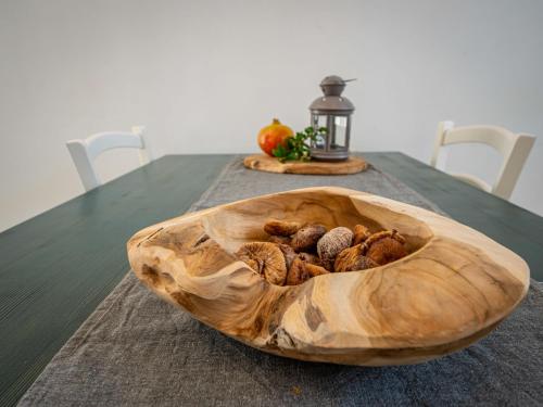 a wooden bowl filled with nuts on a table at Apartment Val-4 by Interhome in Sveti Juraj