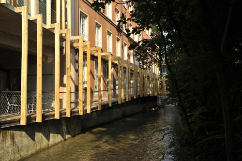 a bridge over a river next to a building at Basel Youth Hostel in Basel