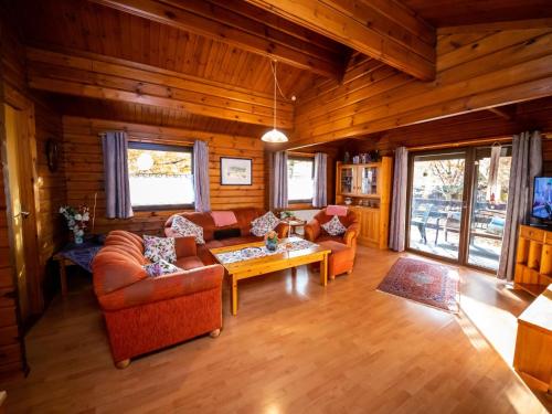 a living room with couches and a table at Chalet Haus 57 Wald Eck by Interhome in Bad Arolsen