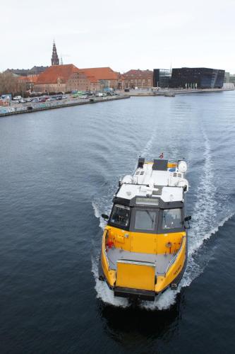 a yellow and white boat in the water at ApartmentInCopenhagen Apartment 200 in Copenhagen