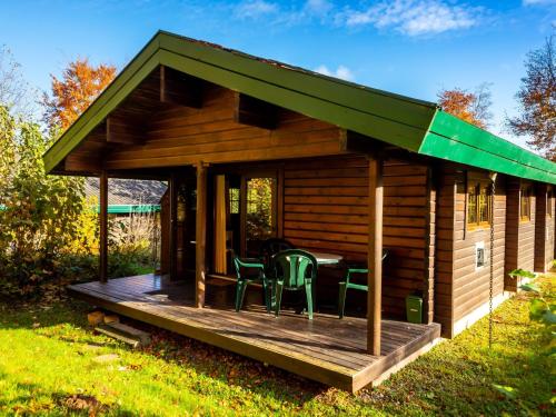 a cabin with a table and chairs on a deck at Chalet Martina by Interhome in Bad Arolsen