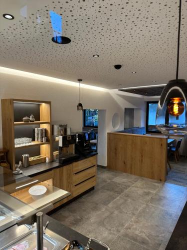 a kitchen with wooden cabinets and a counter top at Hotel Garni Ehrenreich in Sölden
