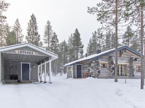 uma cabana de madeira na floresta na neve em Holiday Home Luppokelo by Interhome em Saariselka