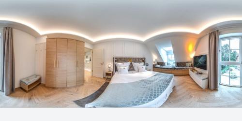 a bedroom with a large bed and a living room at SCHLOSSRESIDENZ - Boutique Apartments & Hotel Suiten in Schloß Ricklingen