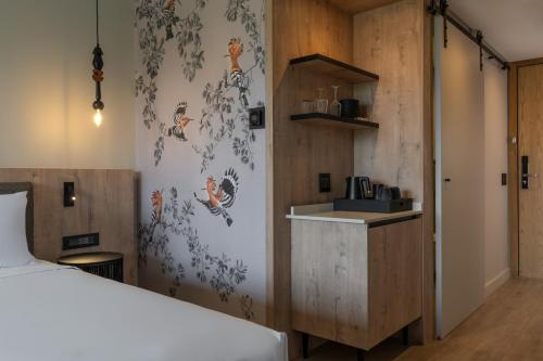 a bedroom with a bed and a kitchen with a counter at Radisson Safari Hotel Hoedspruit in Hoedspruit