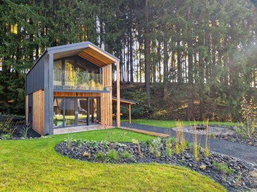 a small house in the middle of a garden at Chalet Luxe Timber Lodge & Pet Retreat by Interhome in Mladé Buky