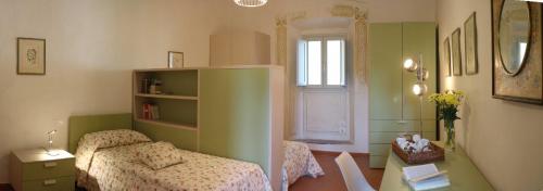 1 dormitorio con cama, mesa y ventana en Foresteria San Niccolò, en Prato