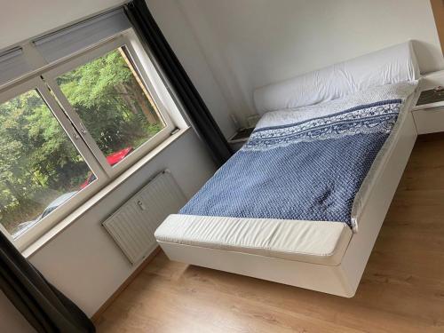małe łóżko w małym pokoju z oknem w obiekcie 3 Zimmerwohnung für 4 Personen w Bremie