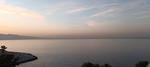 a view of a large body of water at sunset at Blue Seaview Suites in Piraeus