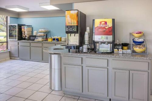a coffee machine sitting on a counter in a restaurant at Days Inn by Wyndham Spartanburg Waccamaw in Southern Shops