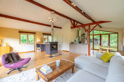 a living room with a couch and a table at Au Ptit Bois Charmant in La Roche-en-Ardenne