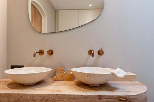 two sinks on a wooden counter with a mirror at Equilodge 't Blommeke - Reconnect with nature in Bruges
