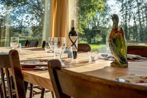 a table with a bottle of wine sitting on top of it at Equilodge 't Blommeke - Reconnect with nature in Bruges