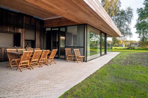 a patio with a table and chairs on it at Equilodge 't Blommeke - Reconnect with nature in Bruges