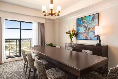 a dining room with a large table and chairs at Embassy Suites by Hilton Orlando Lake Buena Vista South in Kissimmee