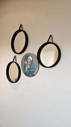 a group of three mirrors sitting on a wall at Le Figuier du Lac Bin elouidane in Bine el Ouidane