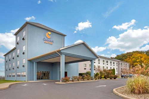 a building with a sign on the front of it at Comfort Suites in Bloomsburg