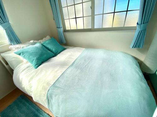 Cama en habitación con ventana en Enoshima Beach - Vacation STAY 07405v, en Fujisawa