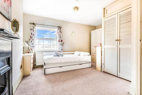 a bedroom with a bed and a window at 2 Bedroom Duplex Apartment in Leicester