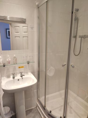 a bathroom with a sink and a shower at Q - Accomodation in Blackpool
