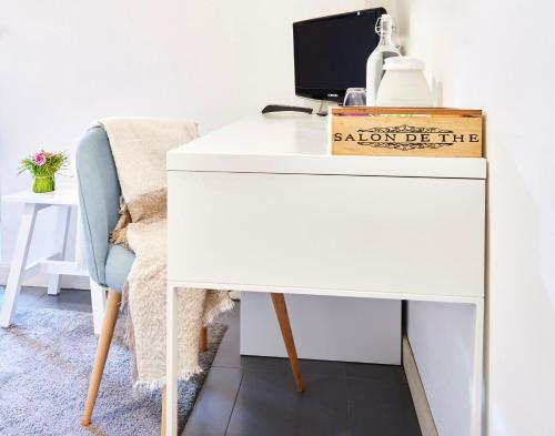 a white desk with a sign on it next to a chair at The Peaceful Apartament Close to Milan in Trezzano sul Naviglio