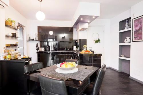 a kitchen with a table with a bowl of fruit on it at The Peaceful Apartament Close to Milan in Trezzano sul Naviglio