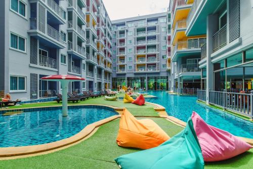 a swimming pool with colorful pillows in a building at Bauman Residence in Patong Beach