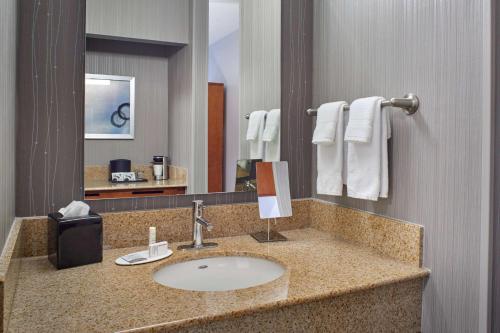 a bathroom with a sink and a large mirror at Sonesta Select Minneapolis Eden Prairie in Eden Prairie