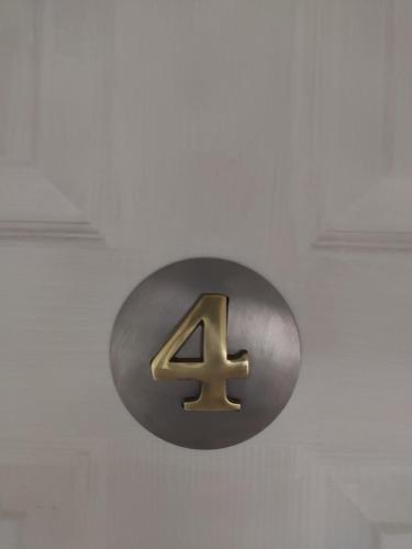 a metal number four sign hanging on a ceiling at Q Accommodation in Blackpool